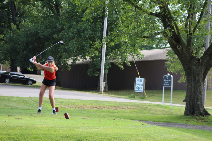 Sophomore Izabella Corcoran is getting ready to swing and hit the golf ball.