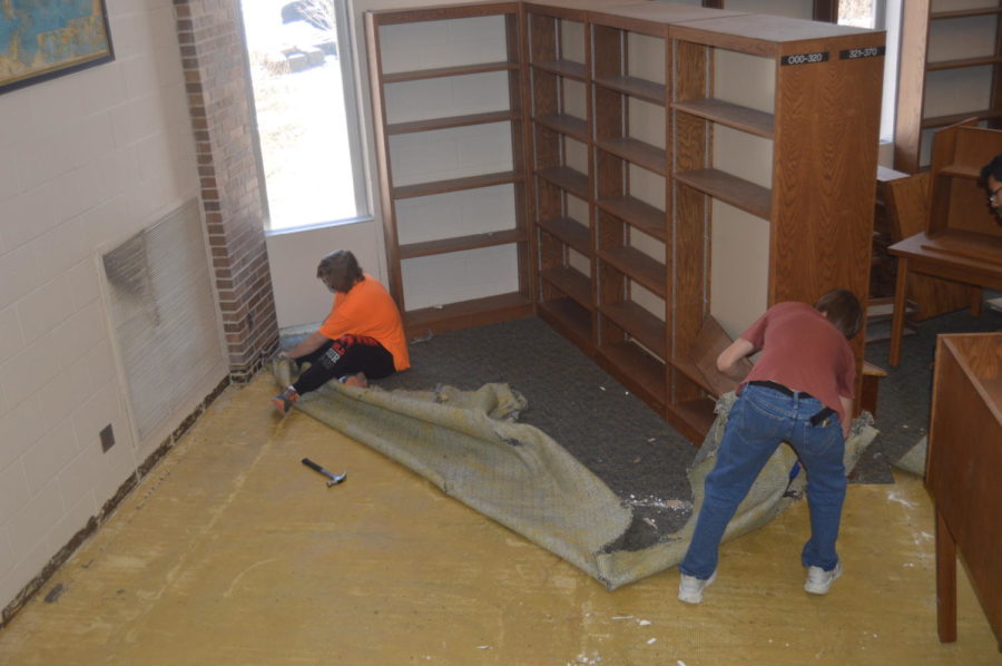 Junior Jordan Tidler and junior Bodie Jones working together to rip up carpet. 