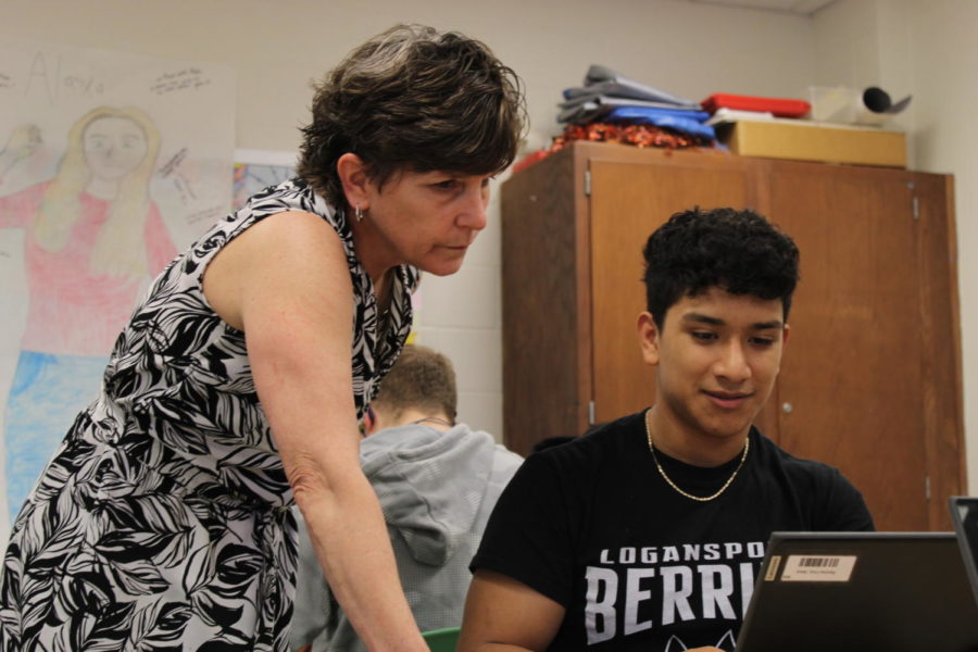 (Above) English teacher and Tattler advisor Beth Myers helps senior Jesus Ramirez with his work.