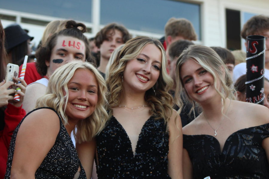 Posing+in+their+Homecoming+candidate+dresses%2C+seniors+Cassidy+Cuppy%2C+Kendall+Sweet%2C+and+Finley+Hettinger+take+in+the+Homecoming+football+game.+Student+Council+hopes+to+give+them+a+chance+to+wear+similar+dresses+at+a+school+dance+later+this+fall.
