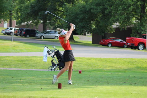 Shooting her first shot of a par 3, senior Chloe Crook swings through the ball with a smooth follow through.