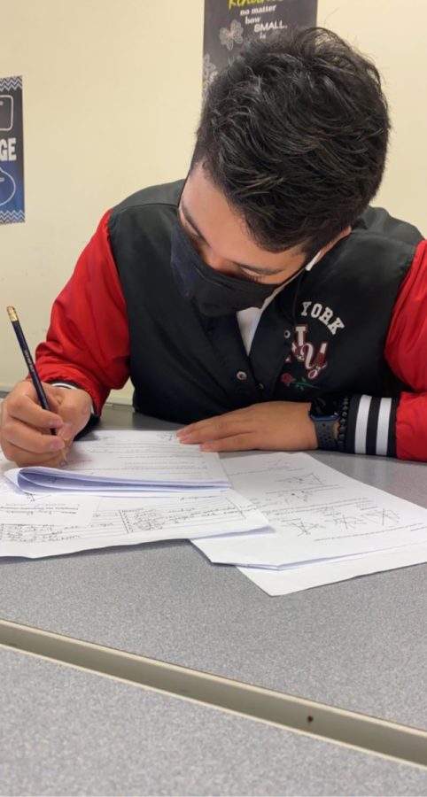 Sophomore Ivy Padilla works on his final review for Geometry Honors.