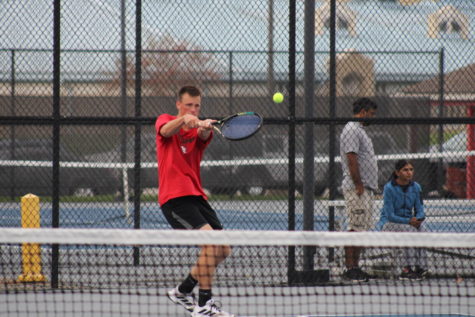 Junior Dylan Pearson follows through after making contact with the  ball during the Logansport vs. Lafayette Jeff tennis match.