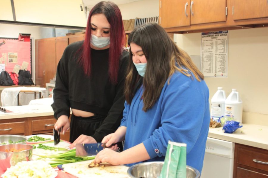 Commonly used in Chinese cooking, scallions (or green onions) and mushrooms are being diced into smaller pieces by sophomores Xander Miller and Jazlyn Hernandez for Guans chow mein.