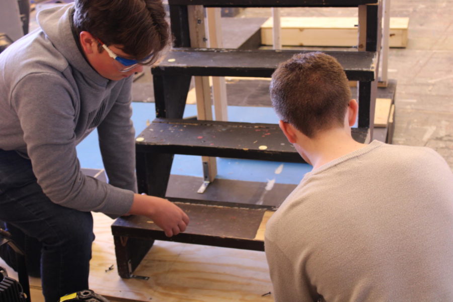  Junior Sam Fultz and Sophomore Justin Snay work together to build stairs for the “Mamma Mia” set. The stairs were built to go in the Taverna scene. 