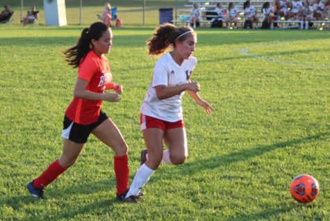 Pursuing the Lafayette Jefferson player, junior Lauren Saldivar try to take the ball from her opponent. 