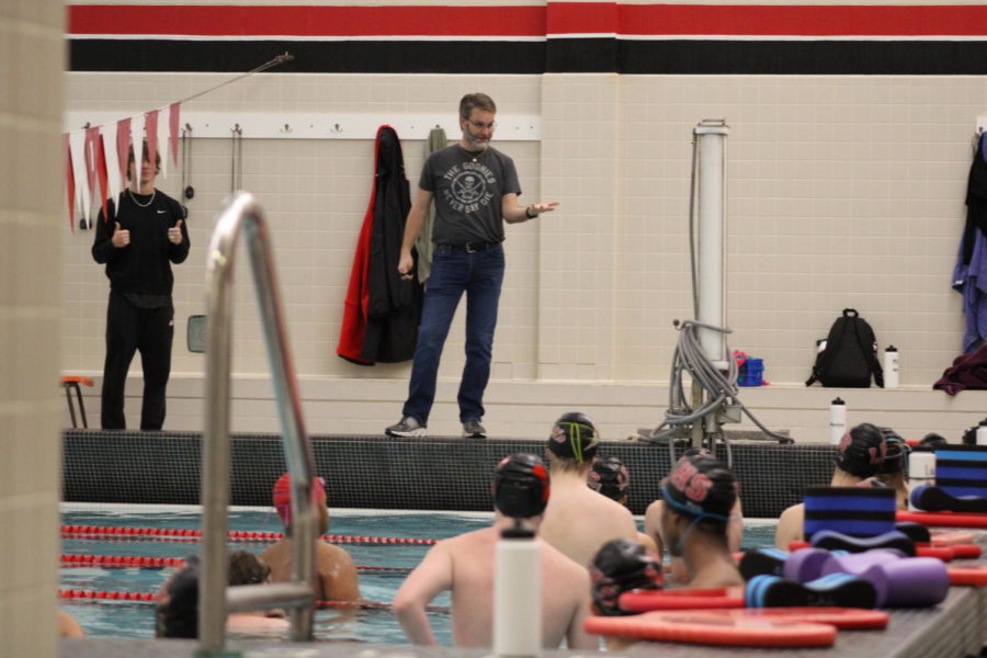 Coach Mike Shannon gives the swim team a prep talk before beginning practice.