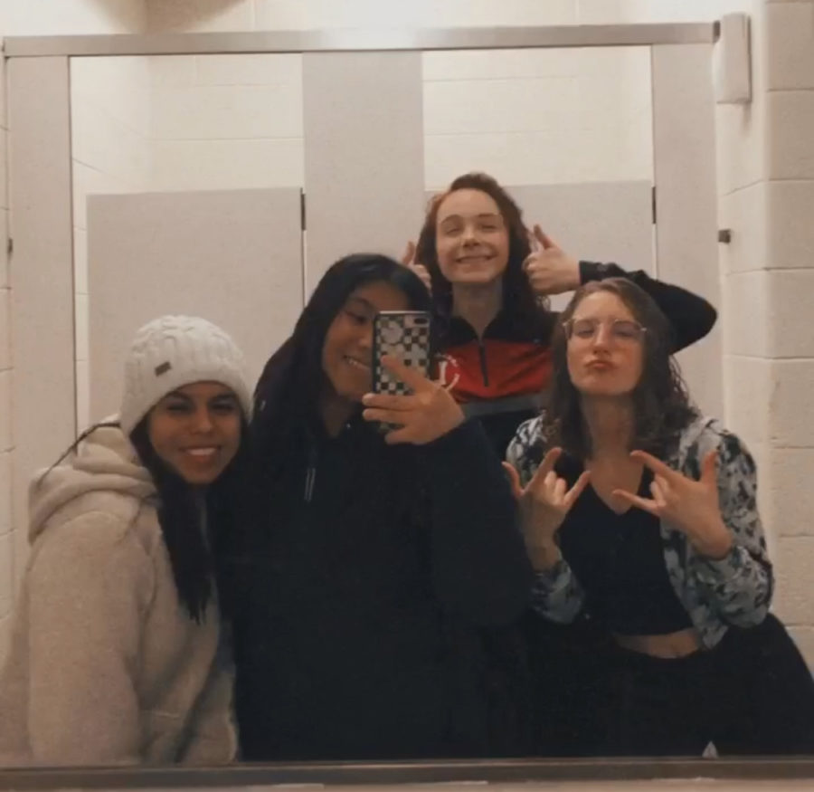  Senior Lacey Ogle, junior Chiara Bosisio, junior Alexia Garcia Perez, and freshman Yalin Torres-Garcia taking a picture in the locker room after there first swim meet.