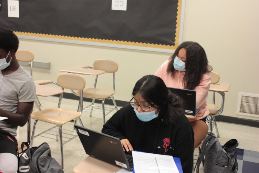 Erica Plutats class works with masks on during a test.