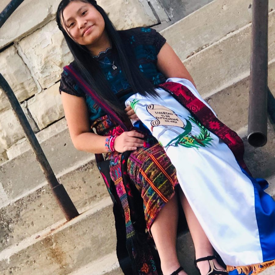 Senior Yesenia Lorenzo  poses in an outfit from  Guatemala in front of Alfa y Omega Church.