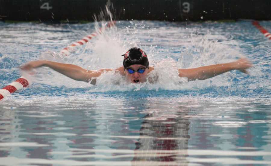Swimming in the fly event, senior Connor Shannon competes against Culver Academies.
