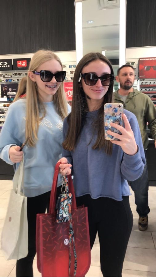 During Black Friday shopping, freshman Adrienne Scott poses with freshman Teagan Wolf to show off their new sunglasses.