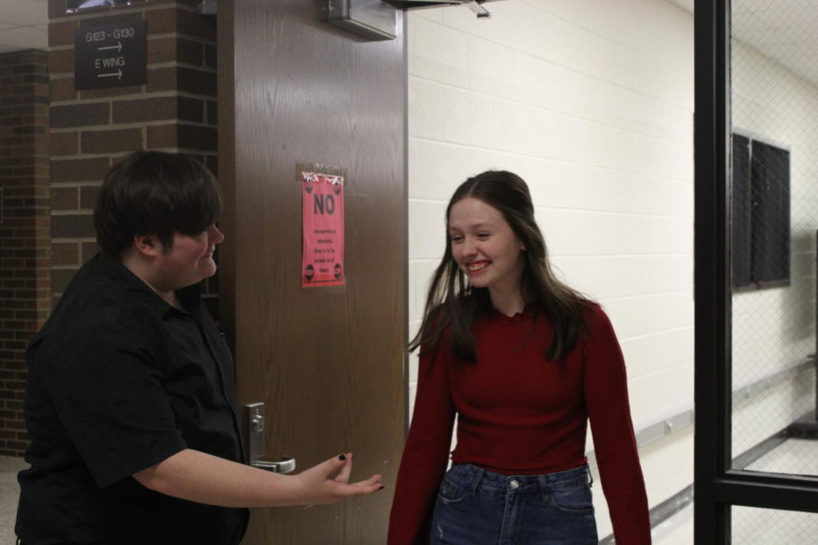 In a common symbol of chivalry, sophomore Jakson Combs holds the door open for junior Gretchen Prifogle.