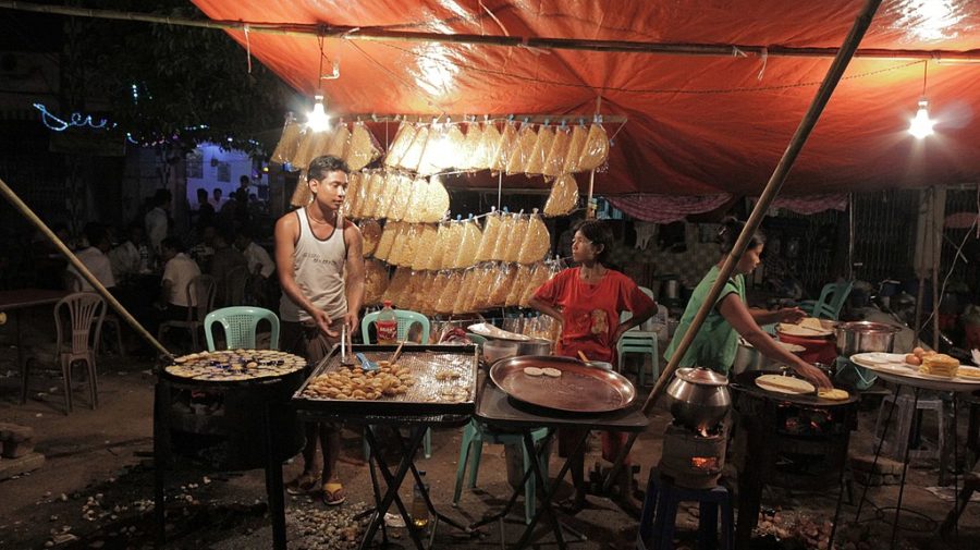 A family business was really common in Myanmar. This family is preparing food for the people attending the festival. 