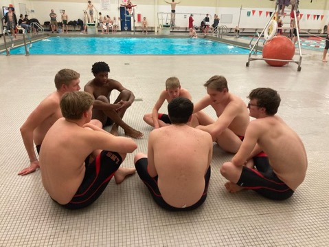 At the Warsaw Boys Swim Sectionals, the LHS swim team stretches before they enter the pool. 
