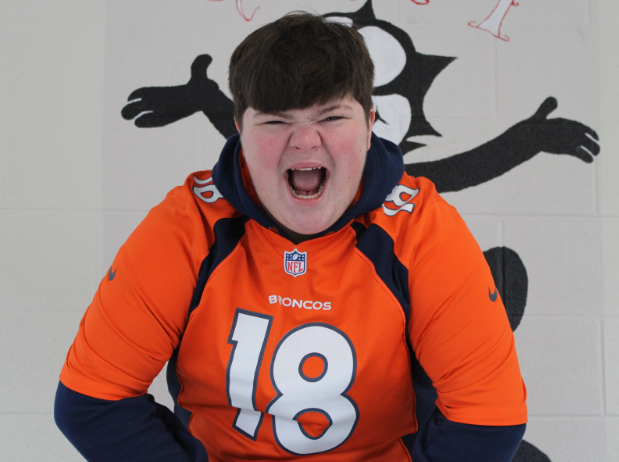 Screaming into the camera, sophomore Jakson Combs wears a Broncos jersey, supporting his favorite team. 