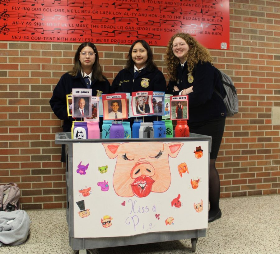 Junior Melanie Contreras, junior Rosie Rodriguez and senior Graci Homburg stand near the main office to ask students for last-minute voting for a teacher to kiss the pig. Throughout National FFA Week, the FFA Club sets up multiple jars for students to drop their loose change in. Each jar has a certain teacher’s photo attached to it. Students put their money in any jar they wanted. The teacher that had the most amount of money in the jar had to kiss teacher Jennifer Fishburn’s miniature pig. All proceeds went towards the club’s funding.