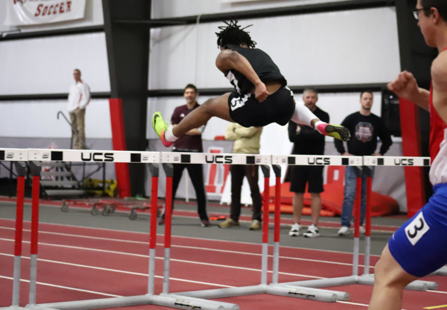 Jumping over the hurdles, senior Chris Rene placed sixth in the 60 meter hurdles race. Hurdles is where runners have to jump over obstacles that are spaced evenly as fast as they can. 