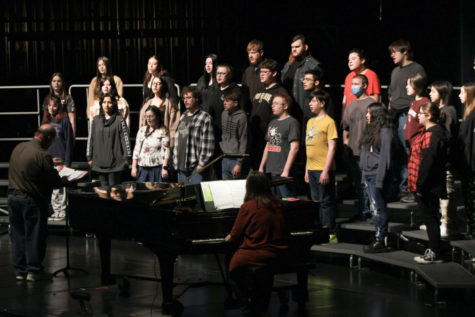 Tim Cahalan helps the Logansport High School Concert Choir makes their final corrections to their songs before the concert. 