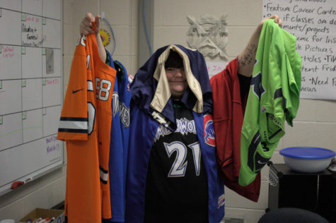Wielding seven of his many jerseys, sophomore Jakson Combs flaunts a portion of his collection.