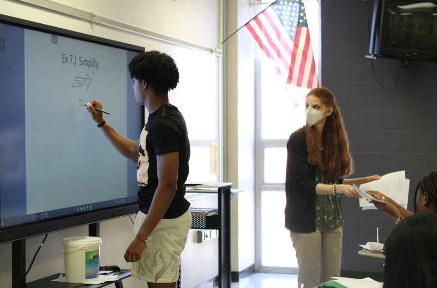 Erin Bauer watches freshmen Albert Ramses Reyes voluneering to answer a math problem on the board. 