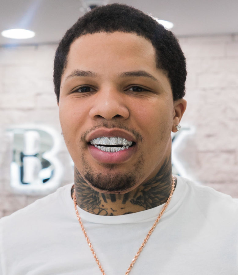 Gervonta+Tank+Davis+shows+off+his+money+by+wearing+grills%2C+earrings%2C+and+a+gold+chain.+