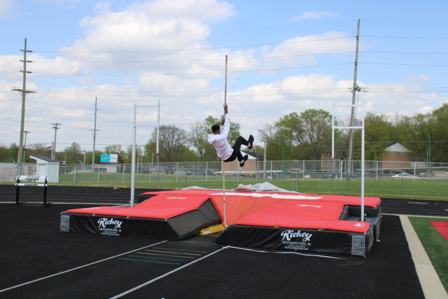 Warming up for the county track meet, senior Juvensley Sejour	practices his pole vault form. 