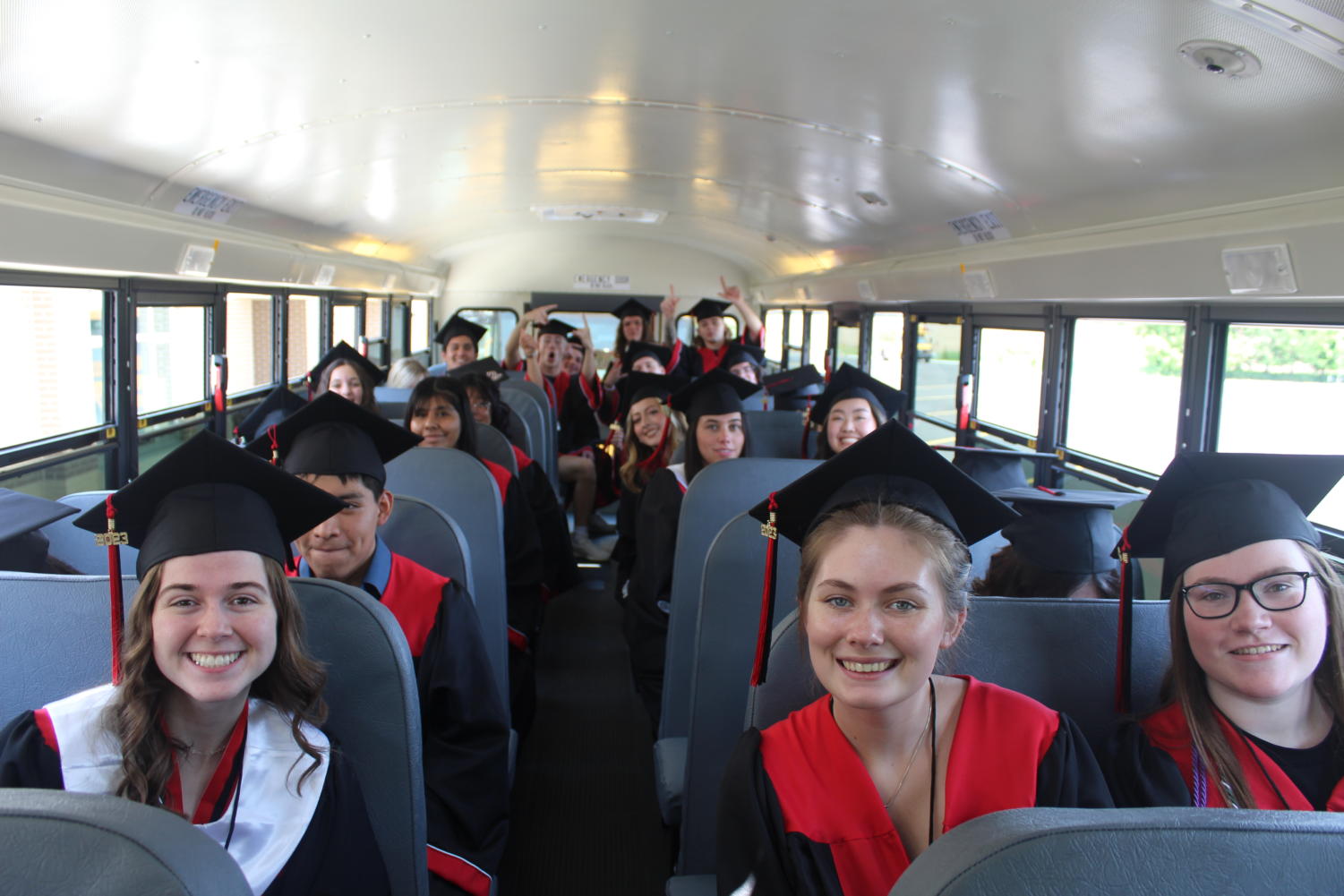 Seniors spend the afternoon riding the bus to different schools during their grad walk.