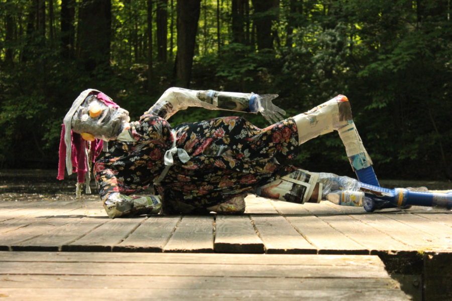 Inspired by seeing their friend lounge about, the creators of La Mamacita  decided to pose her laying down. The 3D sculpture class used plastic, old fabric, and bottle caps in order to make these sculptures.