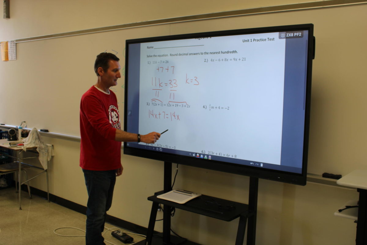 Being one of the many teachers at Logansport High School, math teacher Kevin Reed demonstrates an Algebra 1 equation.