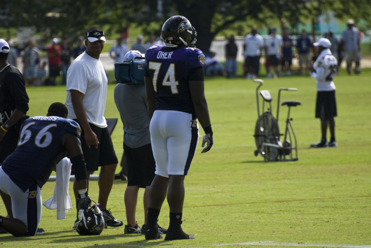 Michael Oher seen as player 74 is seen in full gear, watching a game of golf