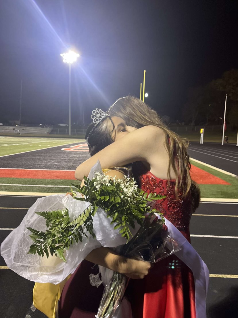 Sanchez is hugged by senior Kylee Langley. They have been friends since sixth grade. Running for homecoming queen together is one of their favorite memories of their senior year so far. 
