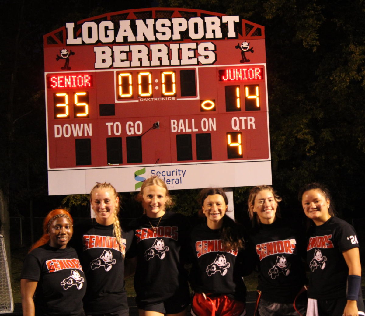 After their win, the Senior Team poses for a photo in front of the scoreboard.