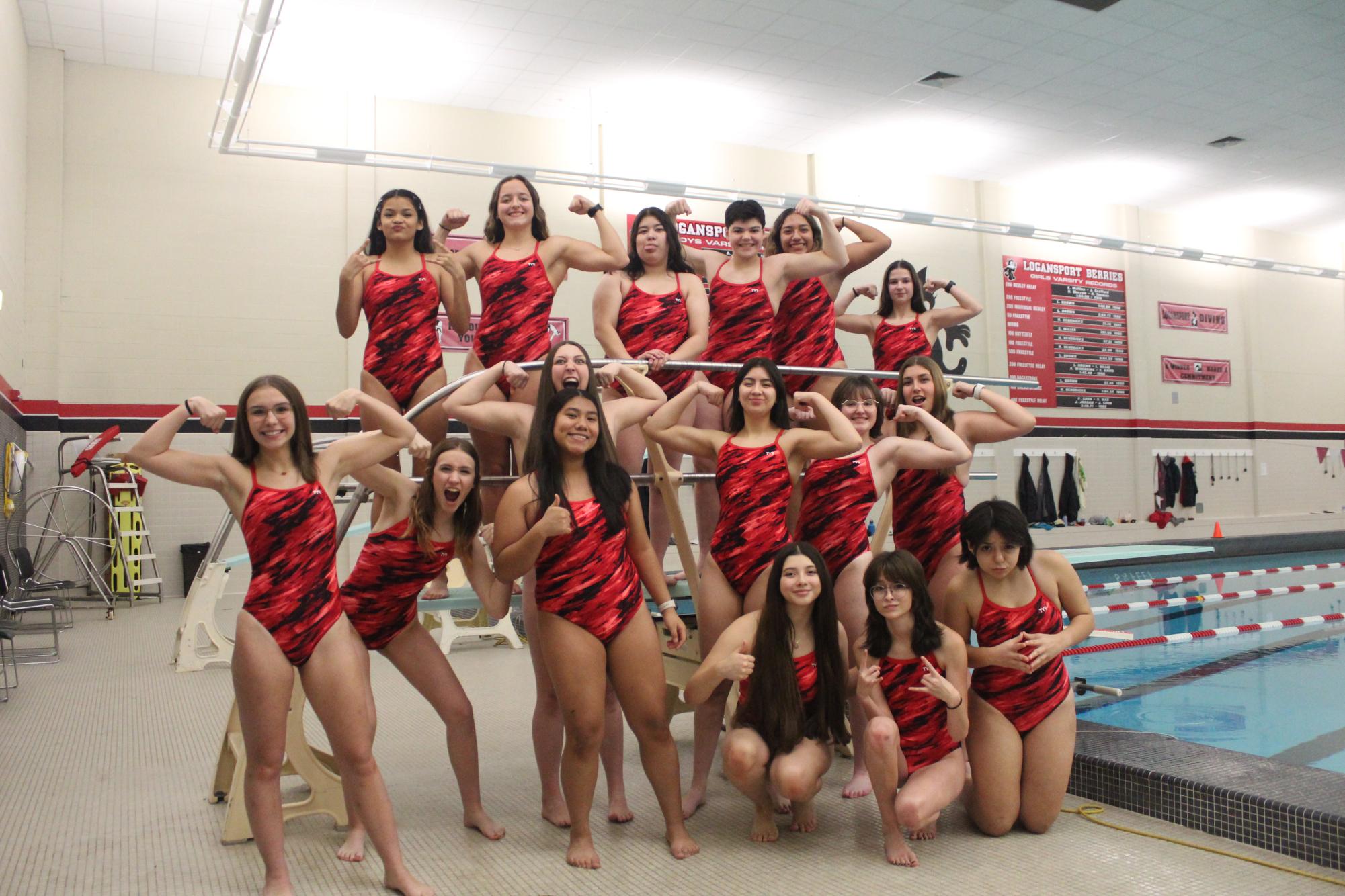 Members of last years swim team have fun posing for a picture.