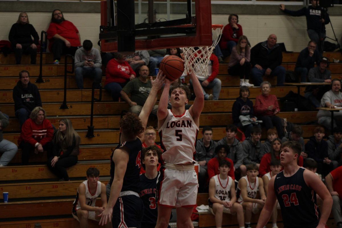 Getting past his defender, senior Jacob  Taylor goes for a layup.