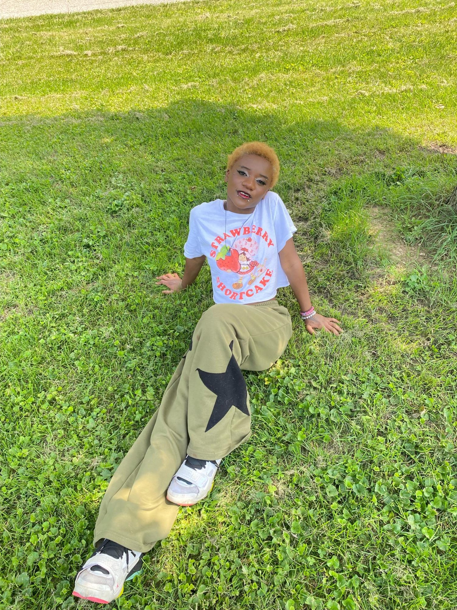 Freshman Martine Metelus poses with her green pants imprinted along with a black star, which was brought from the brand SHEIN.