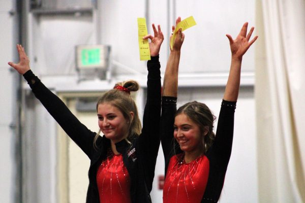 Zimmerman and Benish salute after placing fourth in the Berry Pairs meet.
