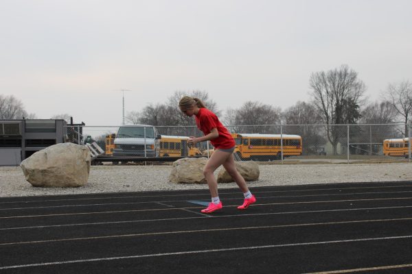 Standing on the starting line, freshman Addie Porter gets ready to run the 400 meter dash.