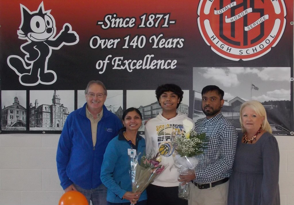 After winning the award, Aryan Patel poses for a picture with his family.