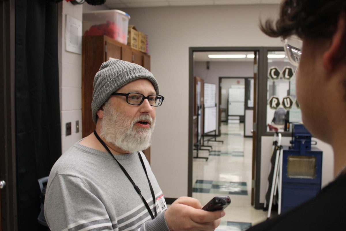 Josh Flynn uses his taperecorder to interview freshman Christain Humana about PTEC.
