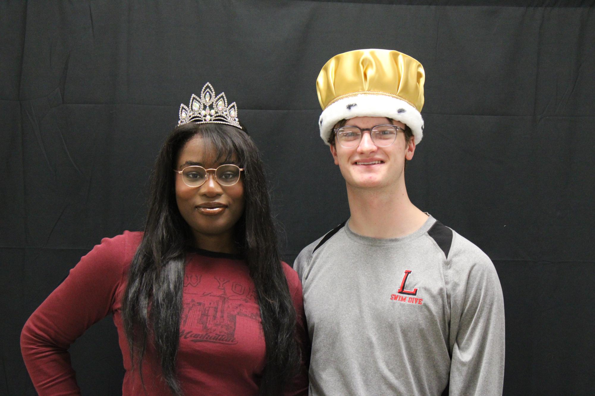 Taking a picture with their crowns, seniors Jake Fincher and Esther BienAiem pose for a photo. 