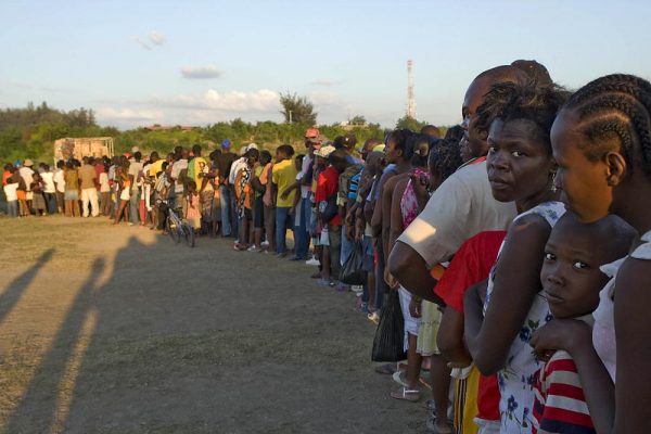 Being displaced by gangs, hundreds of Haitians line up for food distribution provided by the UN.
