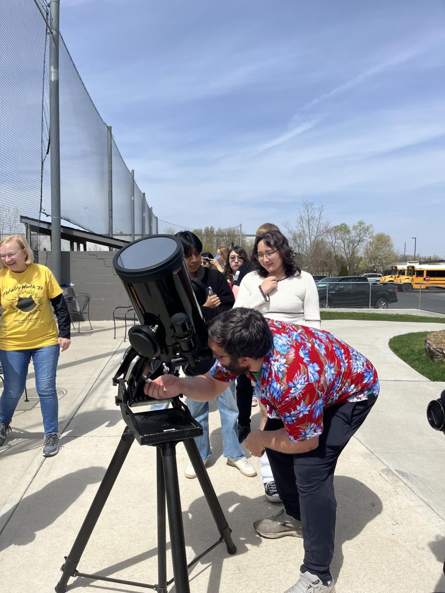 Students wait in line to see the eclipse through the telescope as it progresses. Mr. Bever described seeing sunspots and the chromosphere of the Sun. 