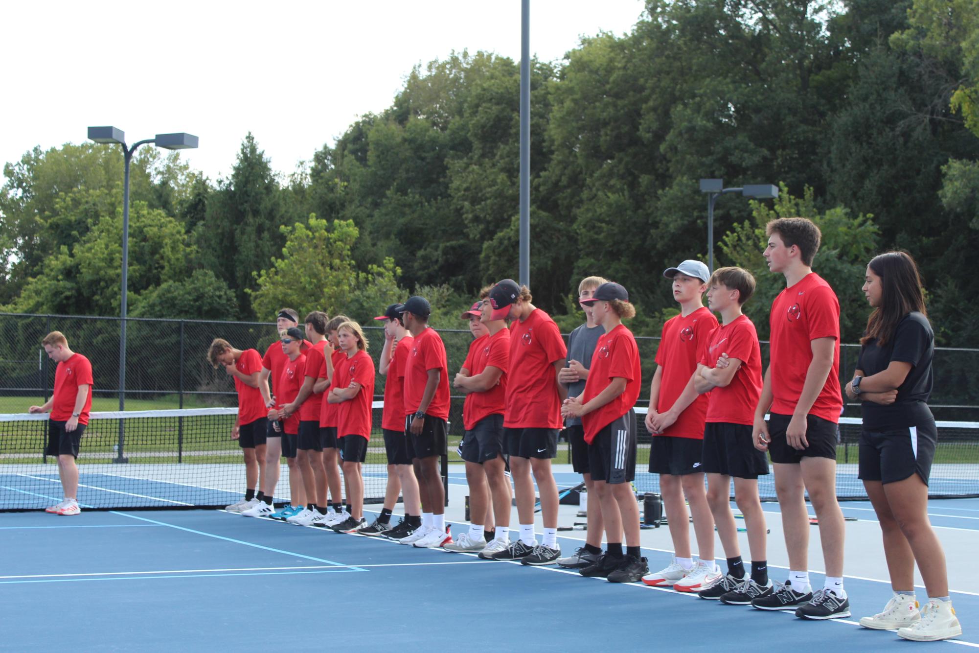 The 2024 Logansport boys tennis team waits to be introduced during a match against Lewis Cass. Managers Blake Pearson and Yuri Servin stand at the front of the line.