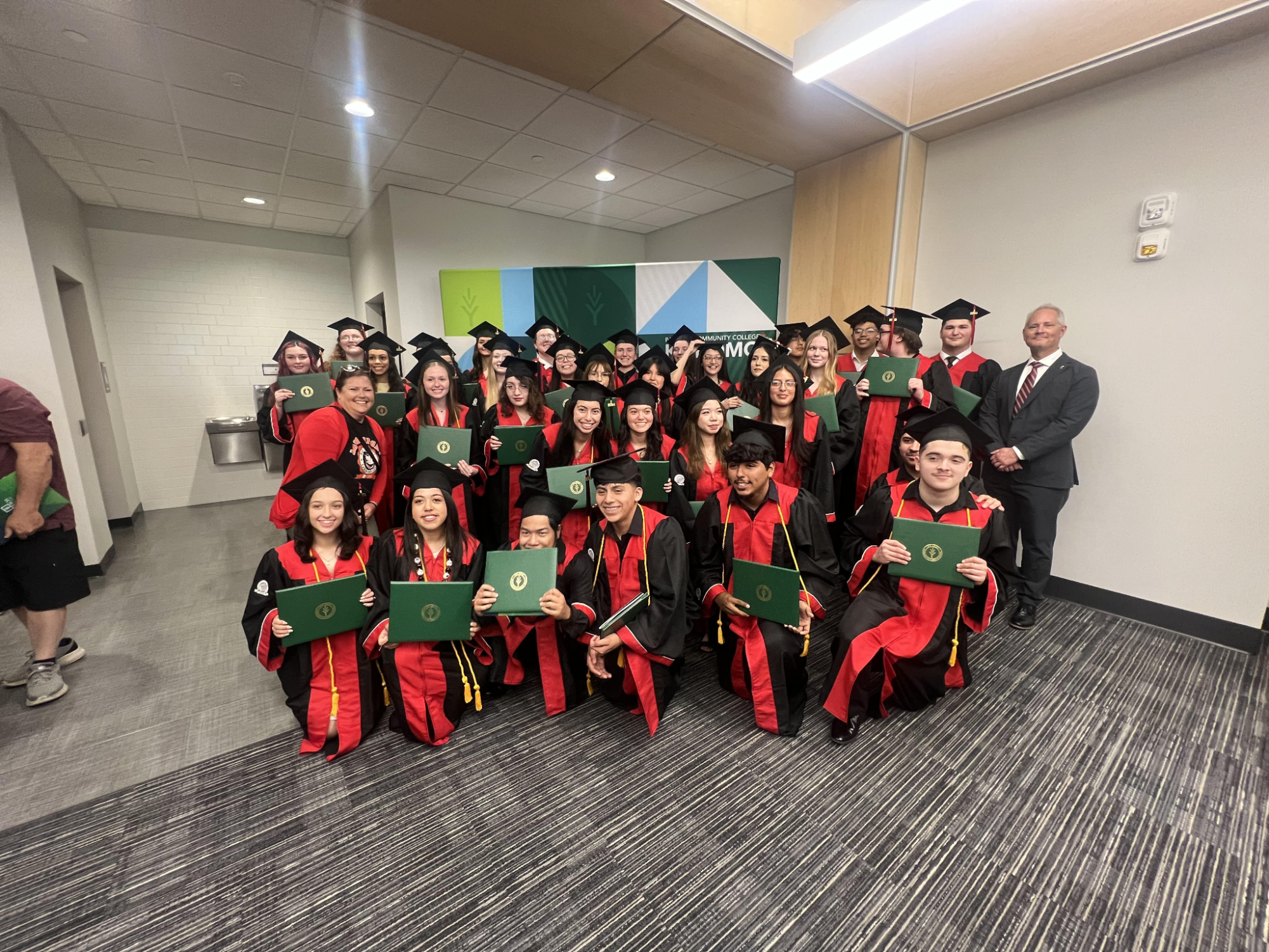 The first group of students who have completed their 4 years with Early College got to hold their diploma next to Matt Jones, the principal. (Courtesy of Abby Lundy)