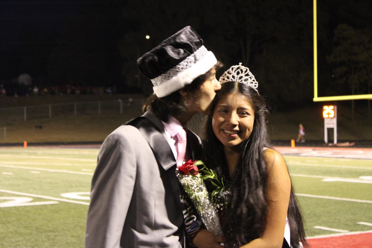 Homecoming King and Queen, Arturo Alvarez-Gomez and Marbella Nievez-Hernandez, pose for a photo after hearing the news that they won. 