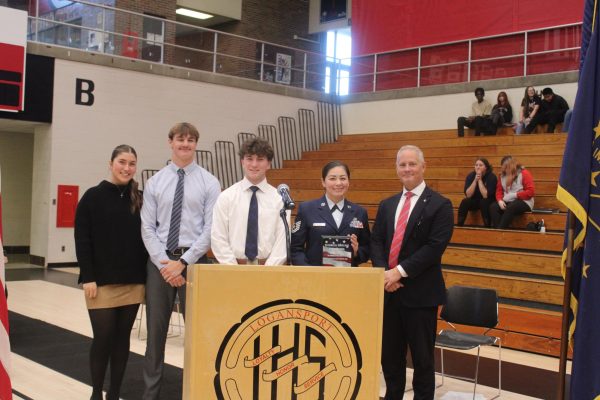 After being presented with the plaque, Principal Matt Jones, Technical Sergeant Lucy Reyna, seniors Emilia Rozzi, Degan Kitchell and Tate Strong stand for a photo as the Magpie, Tattler, Berry Broadcast, and Pharos-Tribune capture the moment. The Berry Bowl was surrounded by photographers and videographers trying to capture the program.