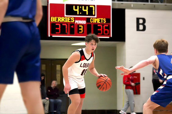 Senior guard Cayden Walker surveys the defense, looking to make a move. 