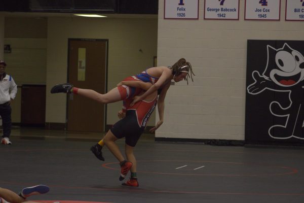 Frame by Frame image of senior Isaiah Guajardo lifting and slamming his opponent.