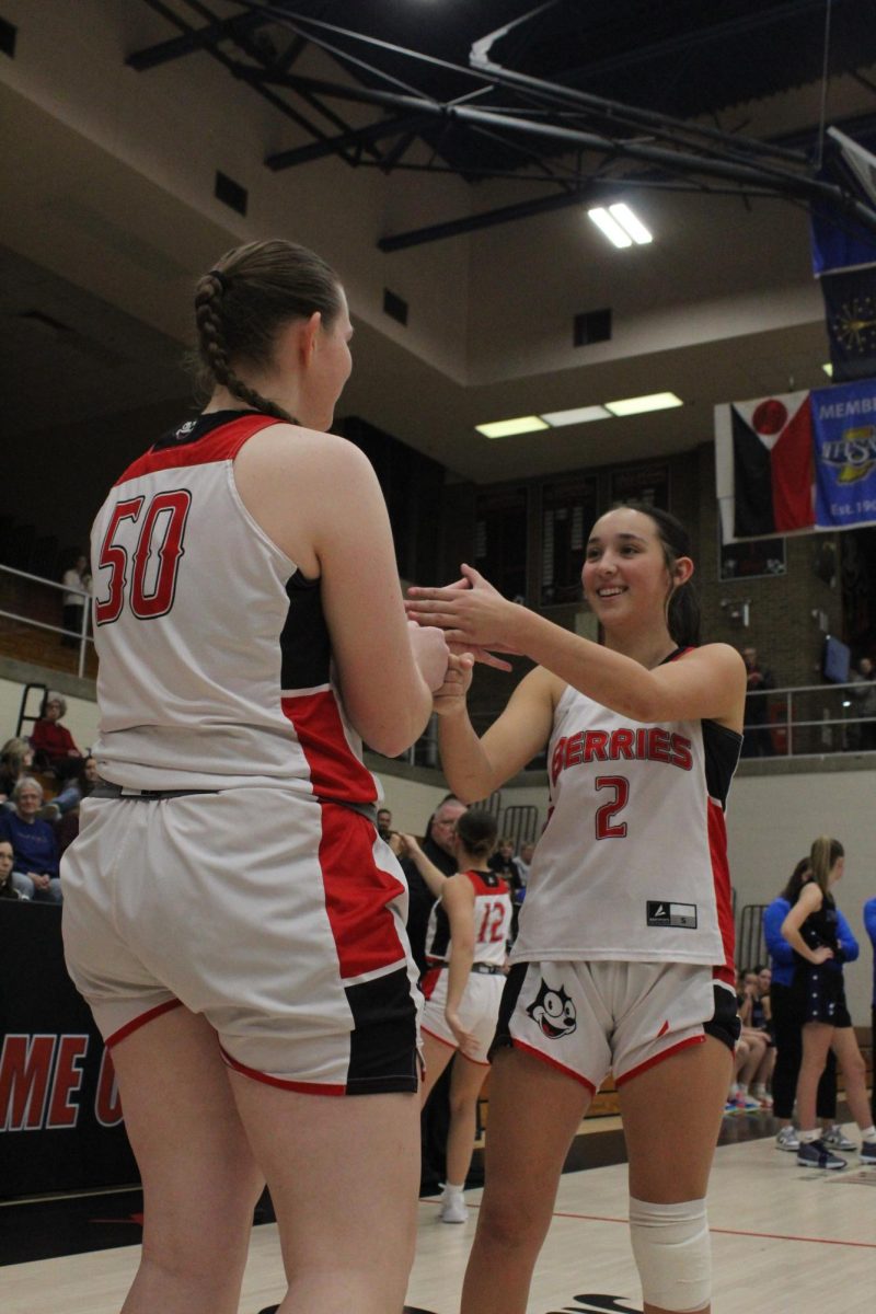 Juniors Golda Kitchell and Maeda Bradbury perform their pre-game hand shake.